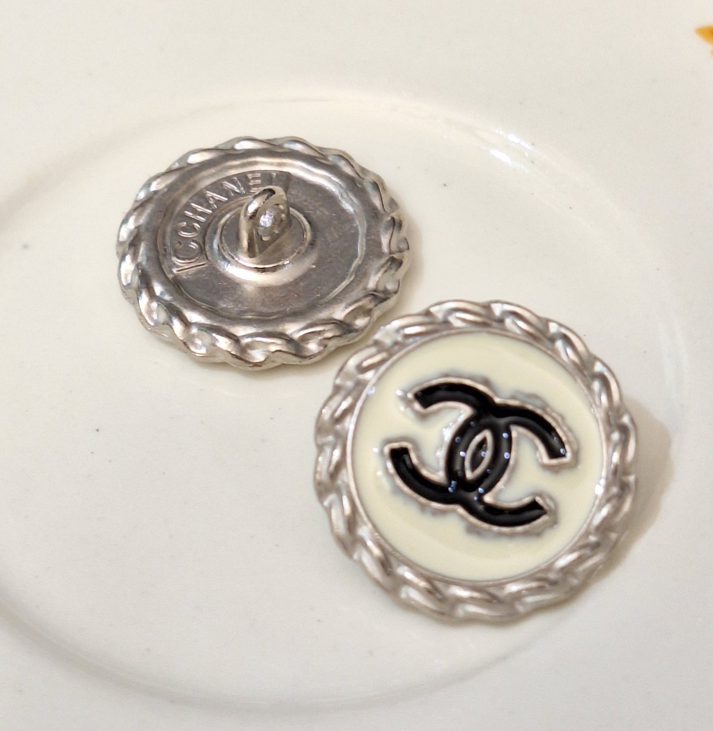 Buttons stamped silver, white, black. 20 mm