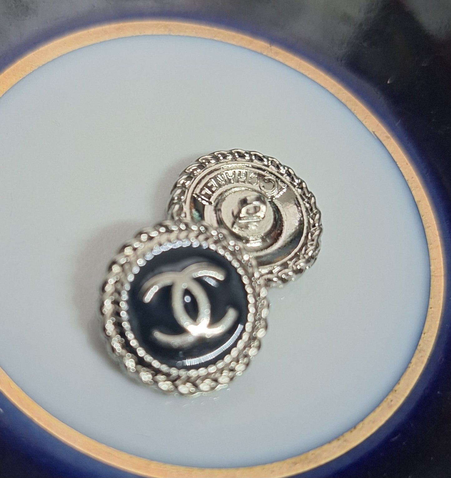 Buttons stamped. Silver & black enemal. 16 mm