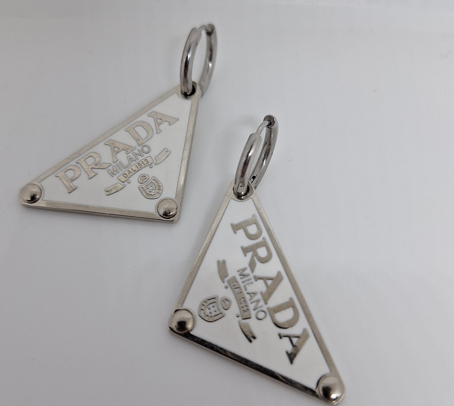 Earings  silver color  and white enemal.  56/24 mm