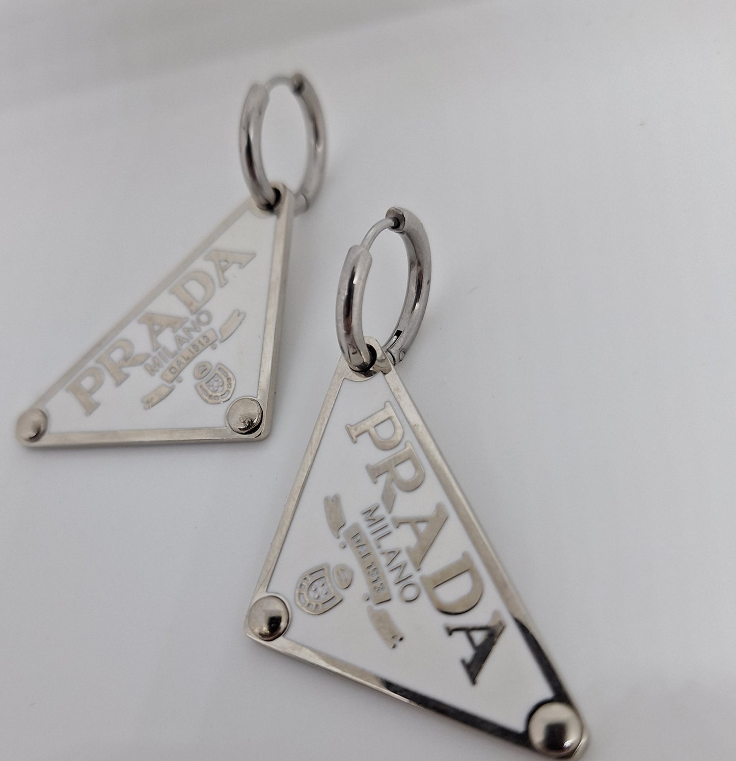 Earings  silver color  and white enemal.  56/24 mm