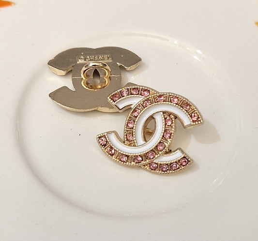 Buttons stamped. Gold, white enemal, pink zircon. 18/22 mm