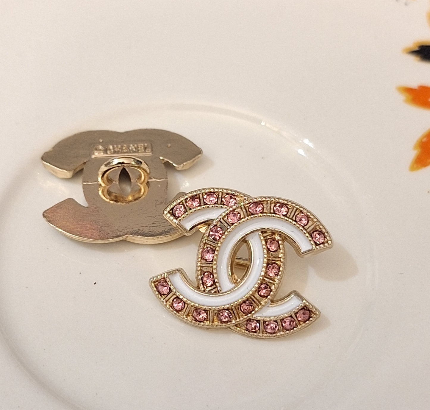 Buttons stamped. Gold, white enemal, pink zircon. 18/22 mm