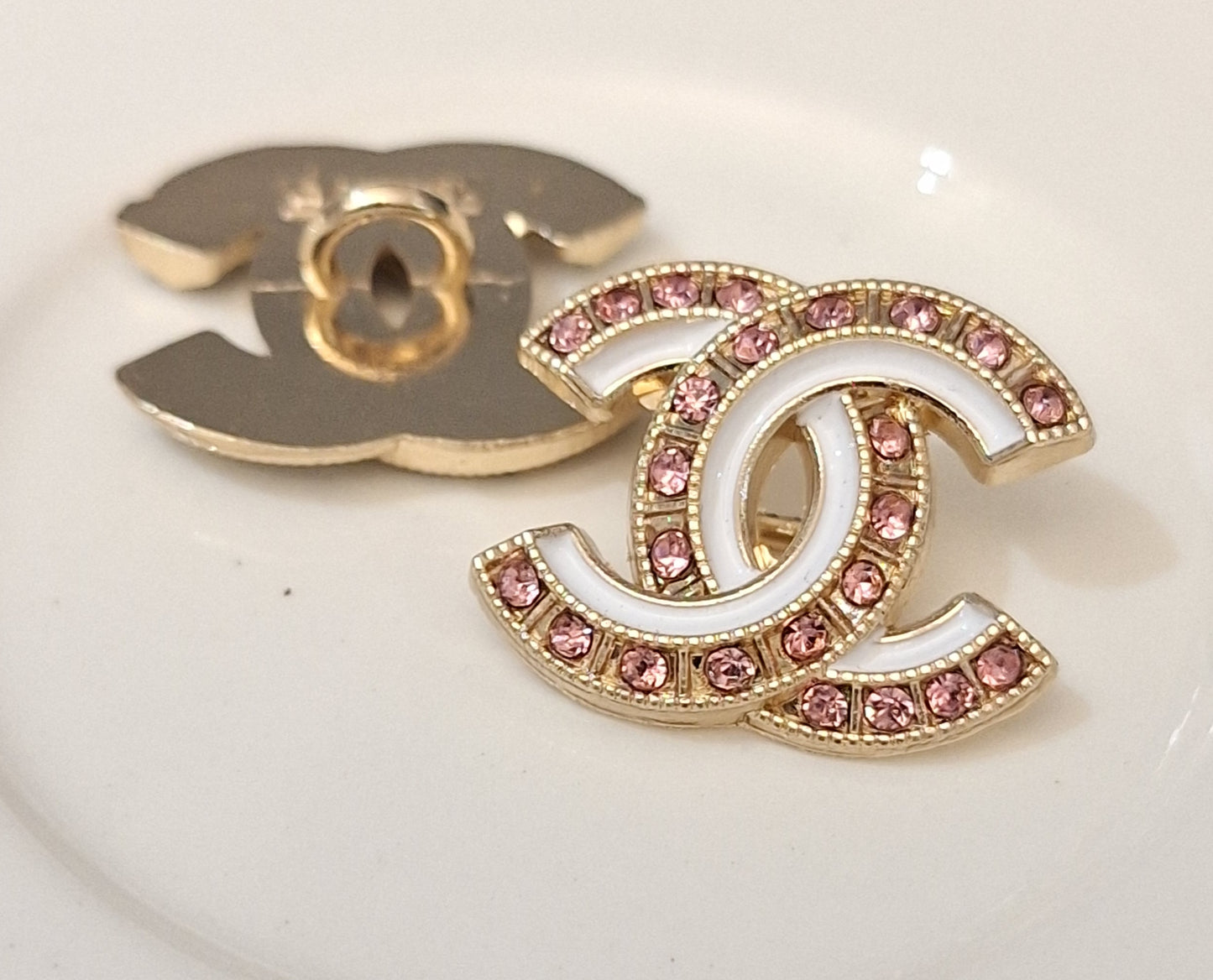 Buttons stamped. Gold, white enemal, pink zircon. 18/22 mm
