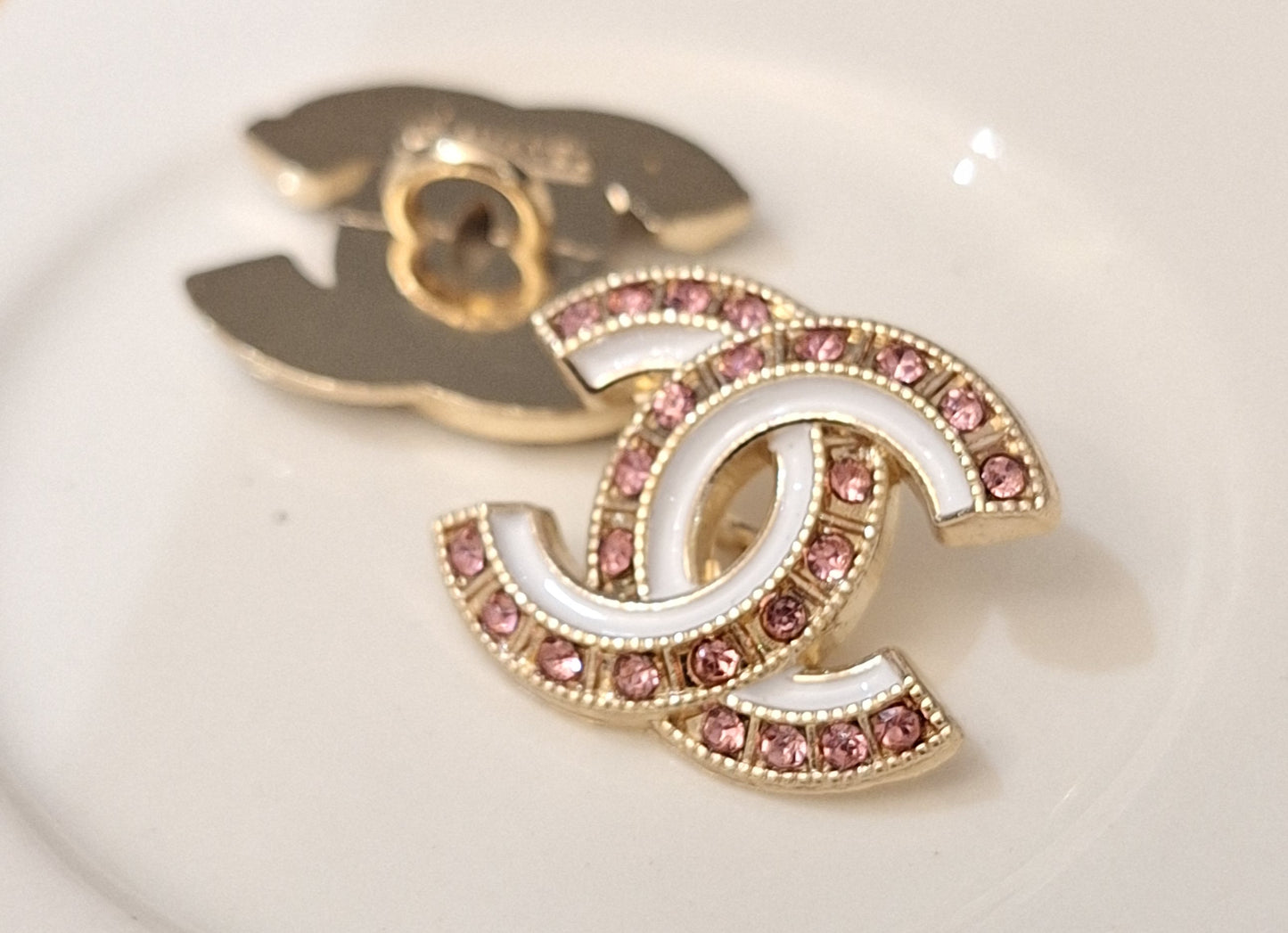 Buttons stamped. Gold, white enemal, pink zircon. 18/22 mm