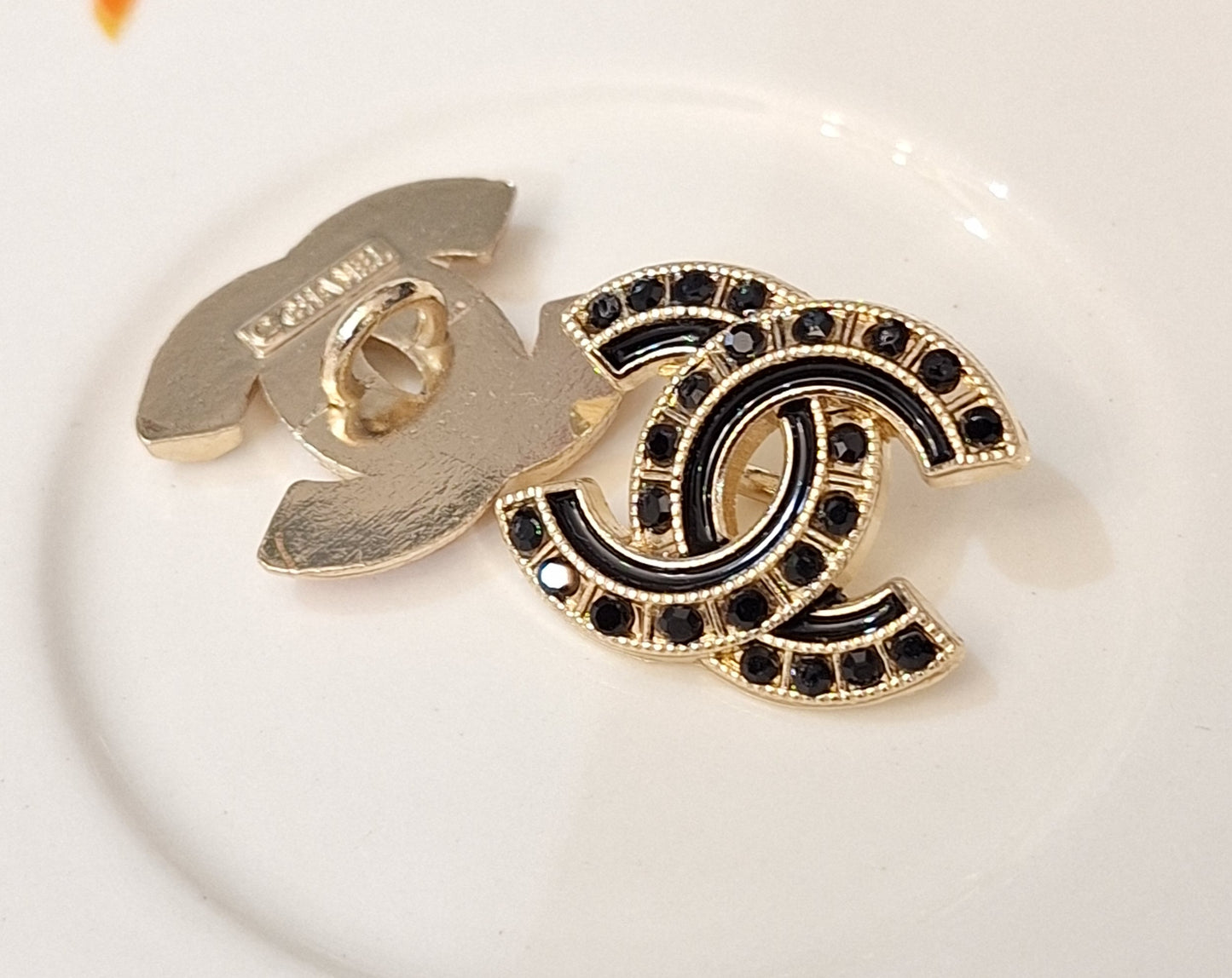 Buttons stamped,Gold, black zircon, black enemal. 18/22 mm