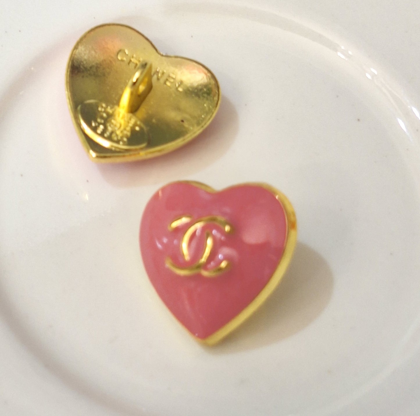 Buttons stamped. Gold & pink. 16 mm