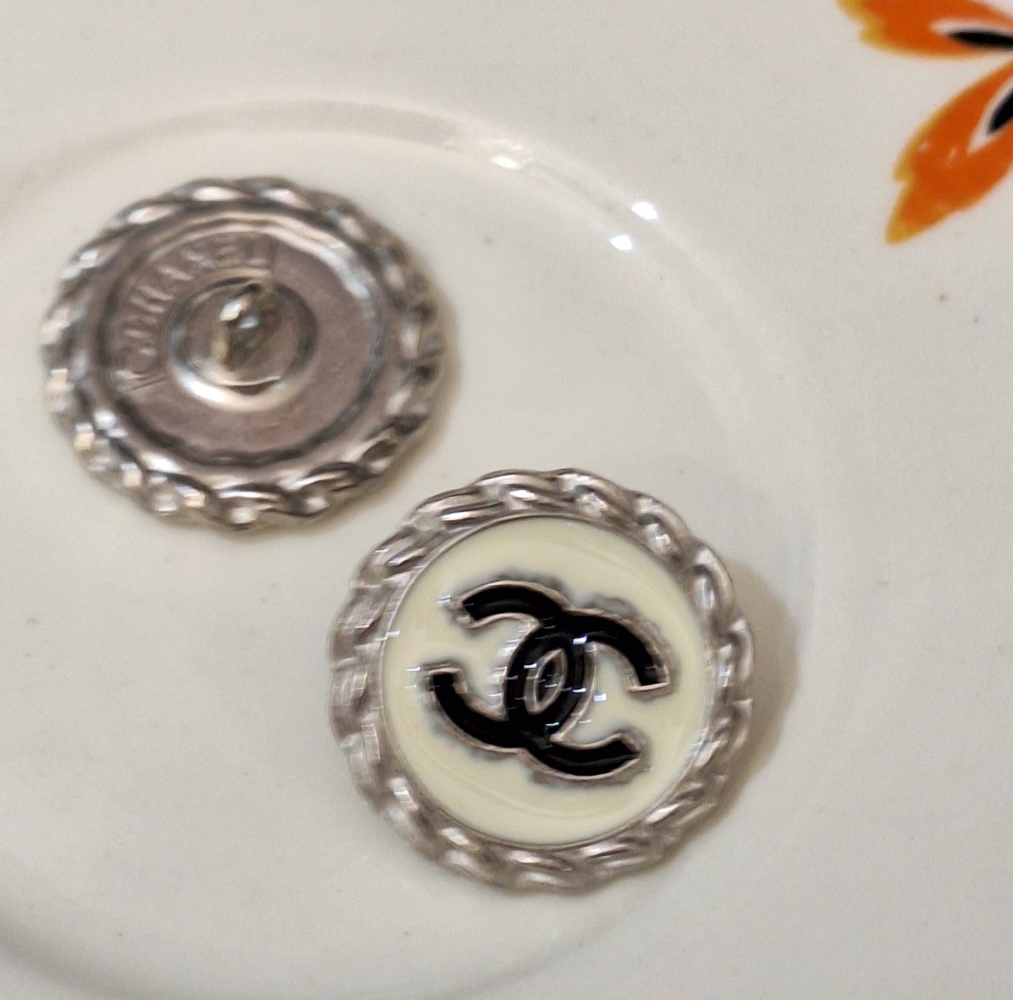 Buttons stamped silver, white, black. 20 mm