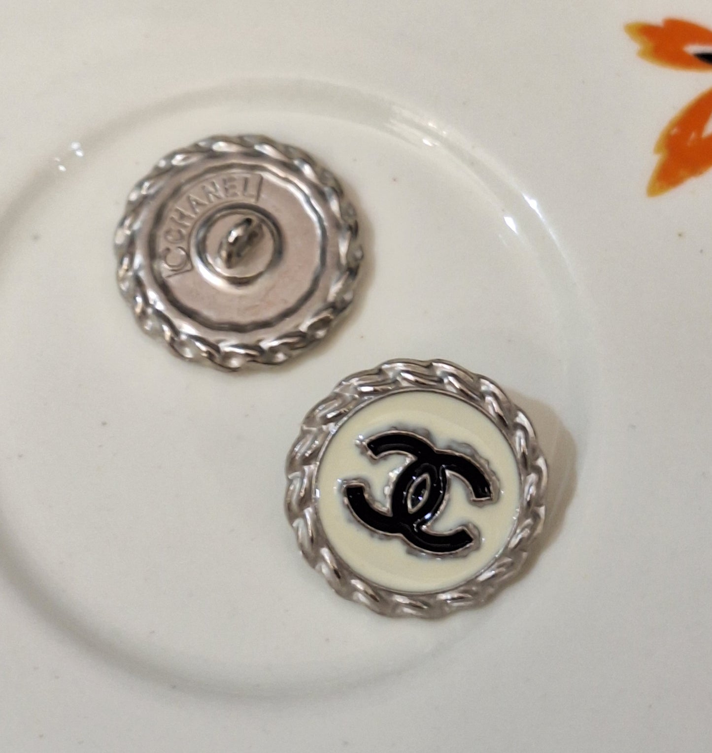 Buttons stamped silver, white, black. 20 mm