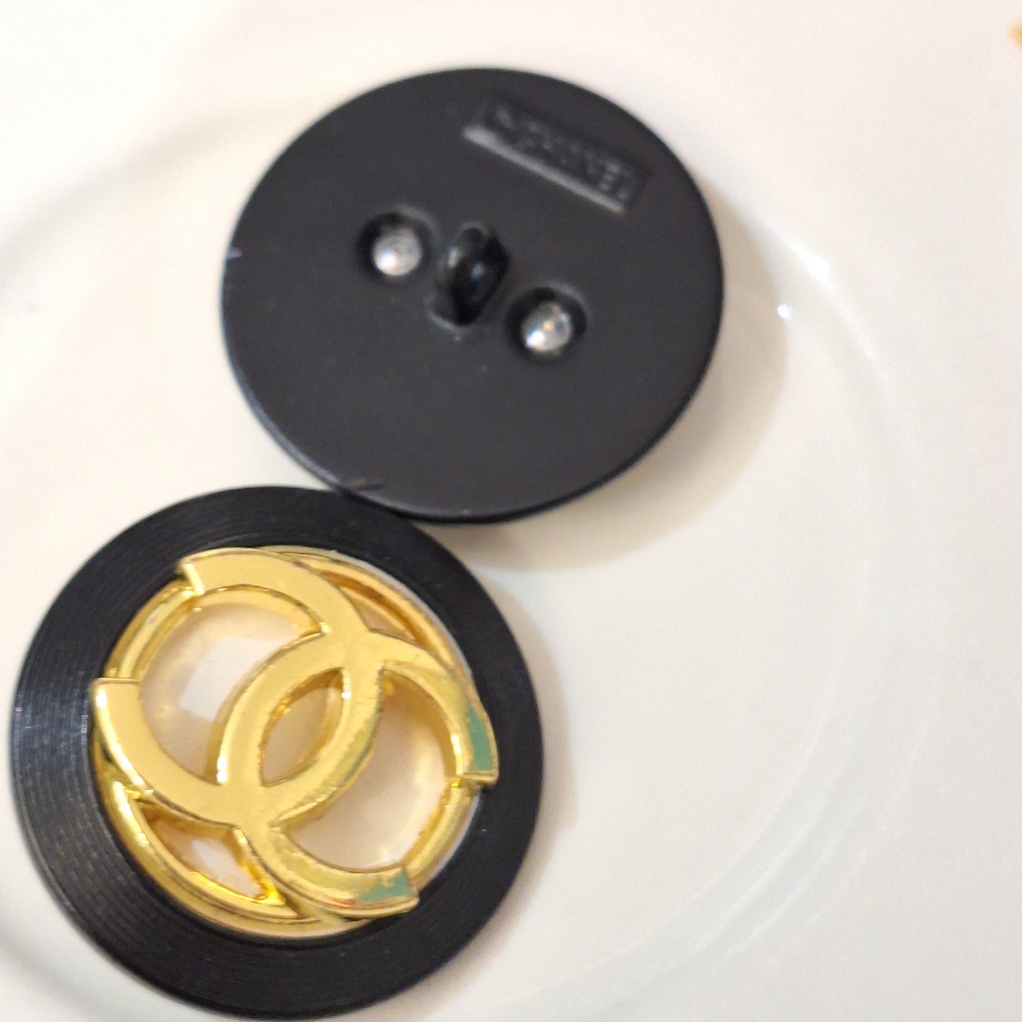 Buttons stamped. Black, white, Gold. 24 mm
