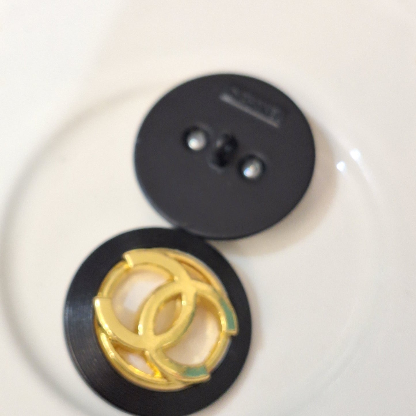 Buttons stamped. Black, white, Gold. 24 mm