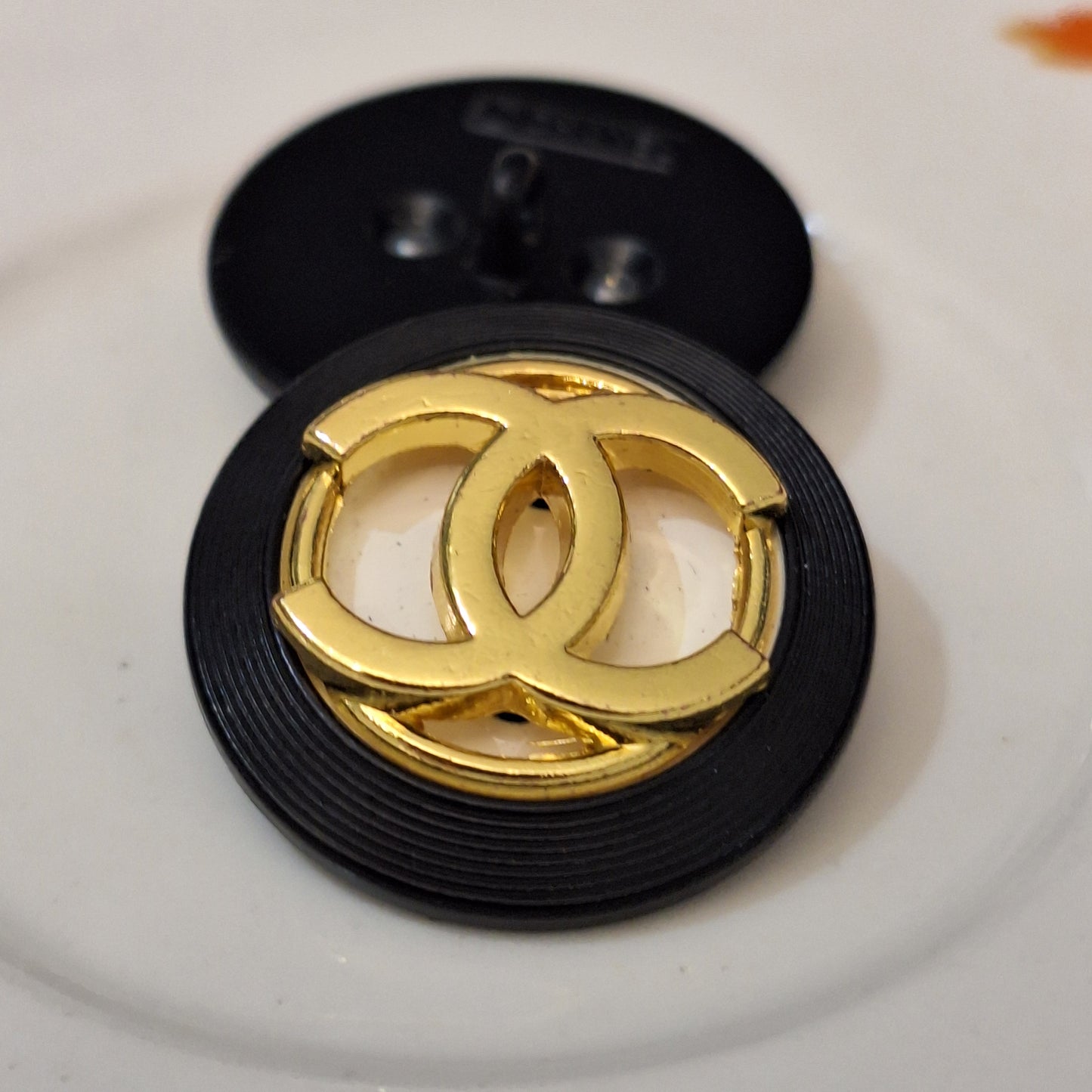 Buttons stamped. Black, white, Gold. 24 mm