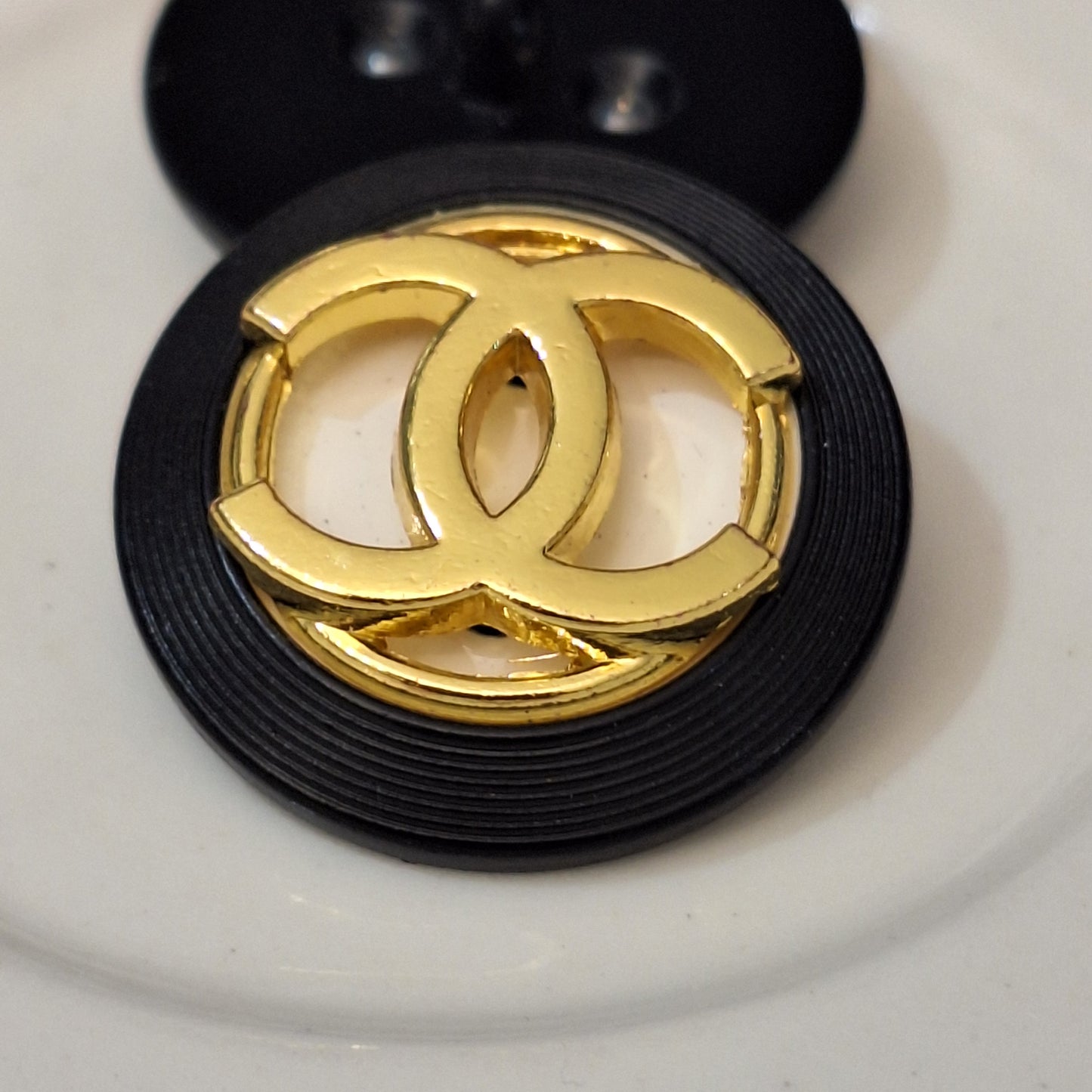 Buttons stamped. Black, white, Gold. 24 mm