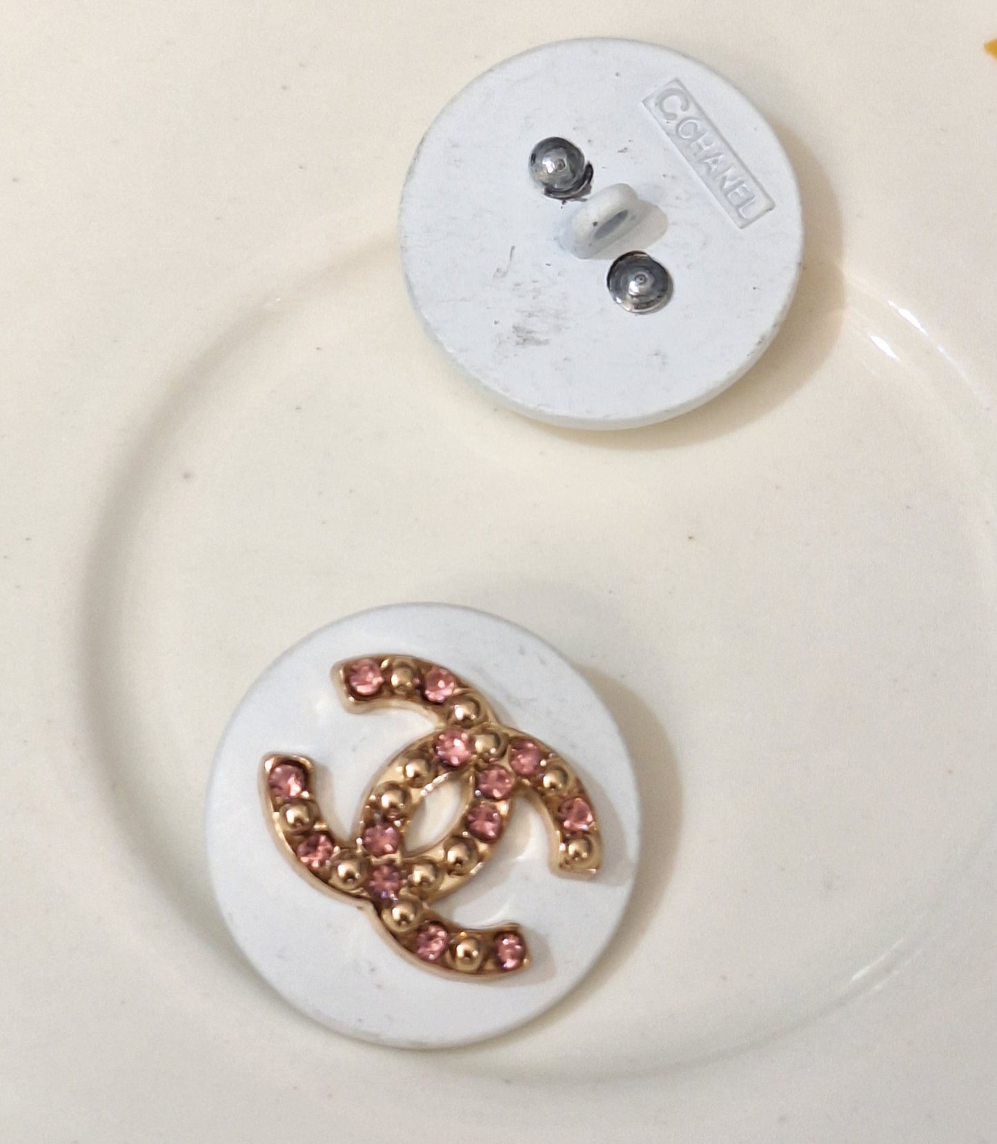 Buttons stamped white, Gold and pink zircon. 22 mm