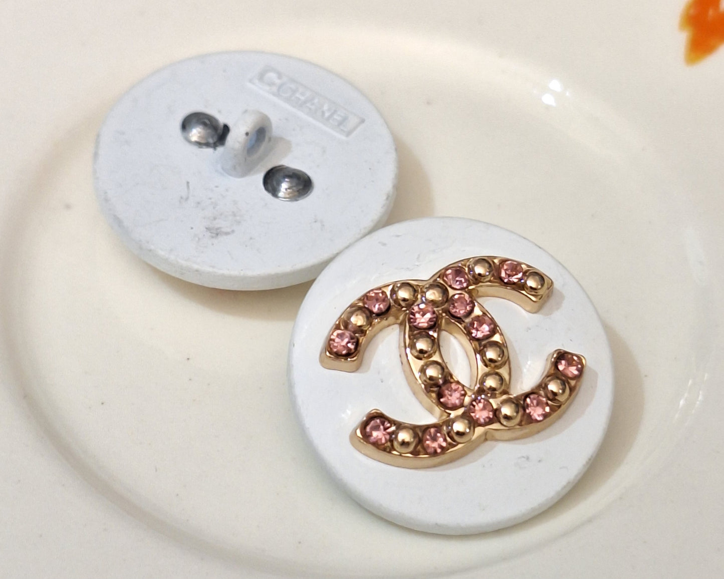 Buttons stamped white, Gold and pink zircon. 22 mm