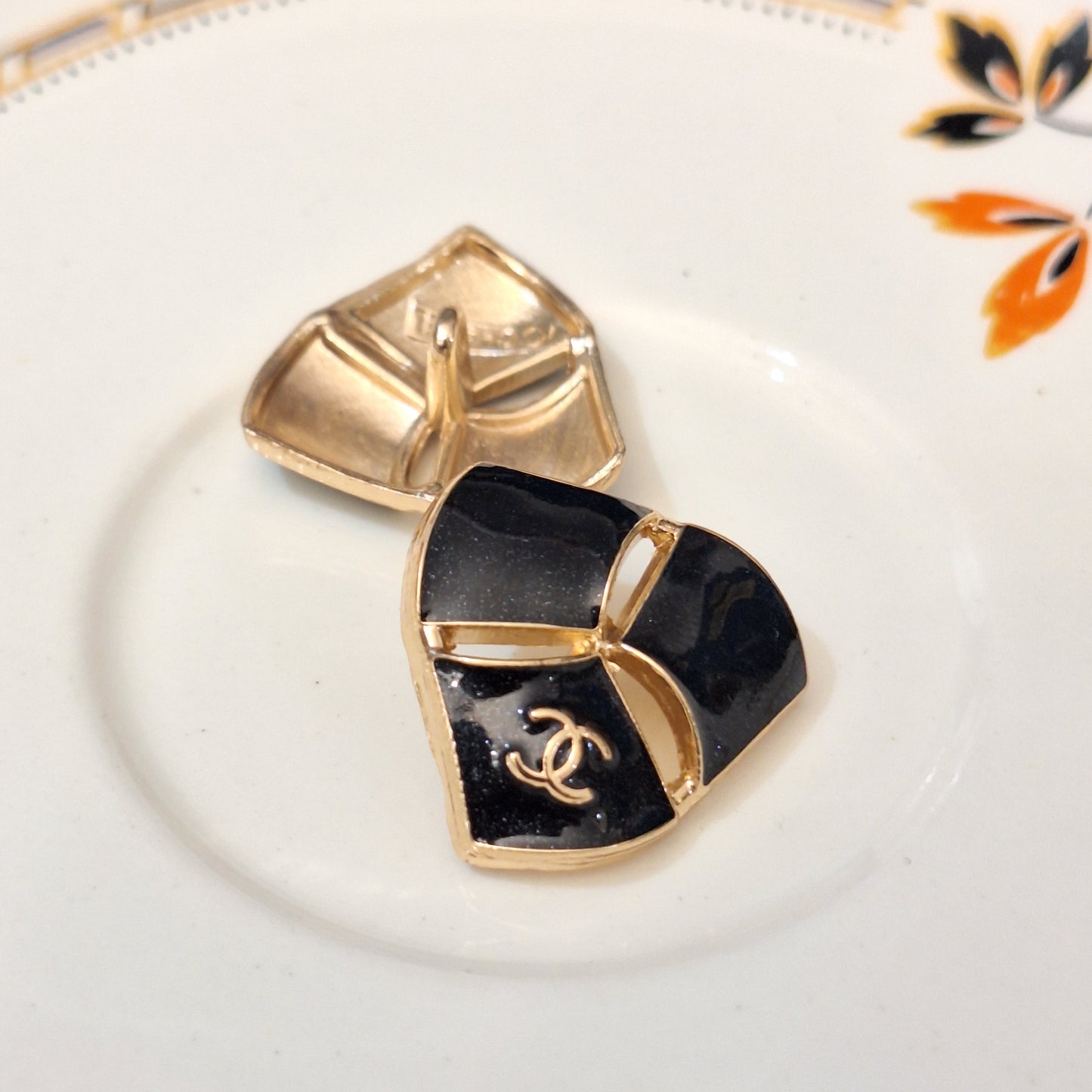 Buttons stamped black & gold.  22 mm
