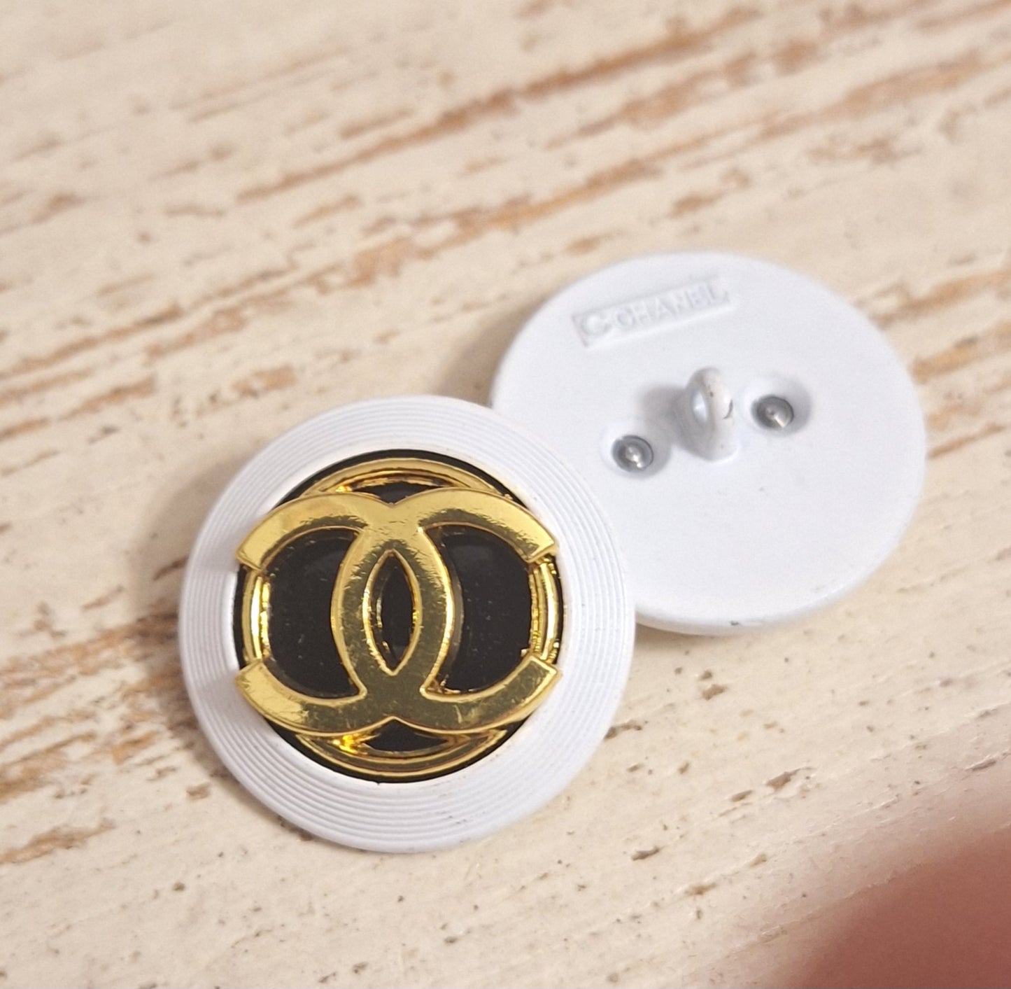 Buttons stamped, white, Gold & black. 24 mm