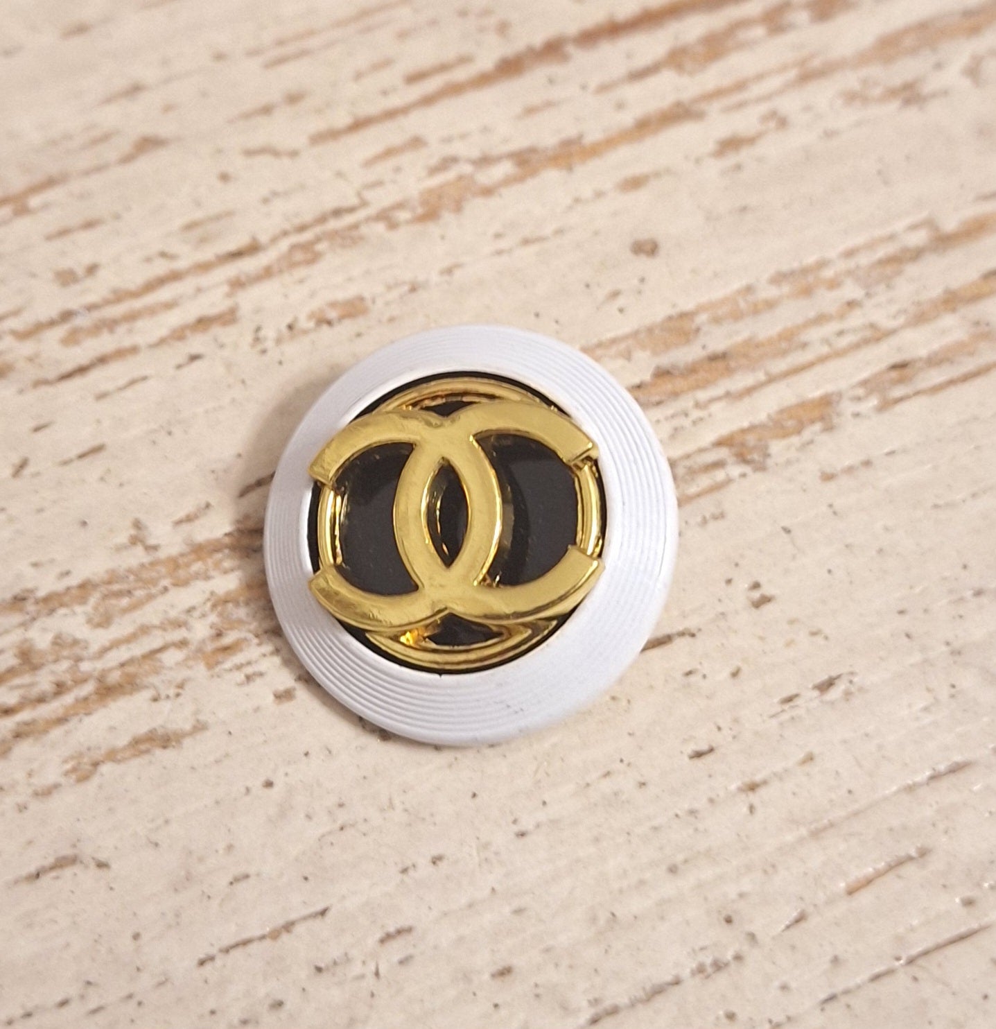 Buttons stamped, white, Gold & black. 24 mm