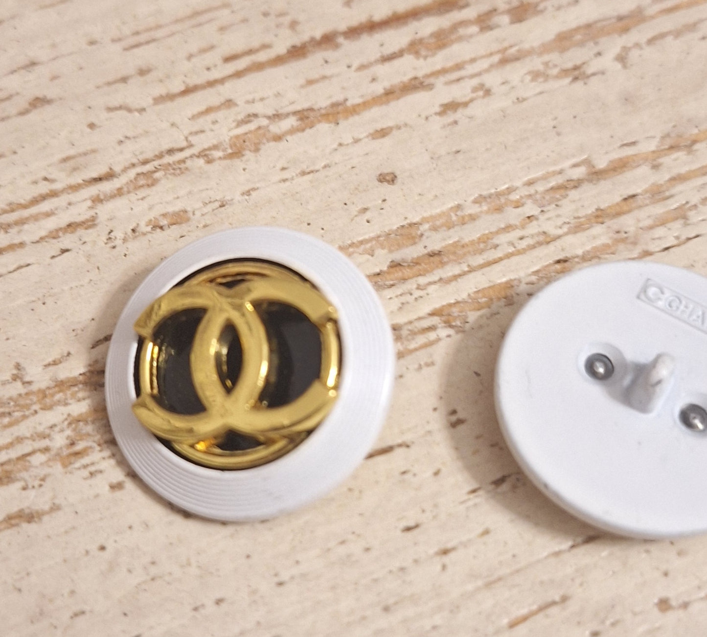 Buttons stamped, white, Gold & black. 24 mm