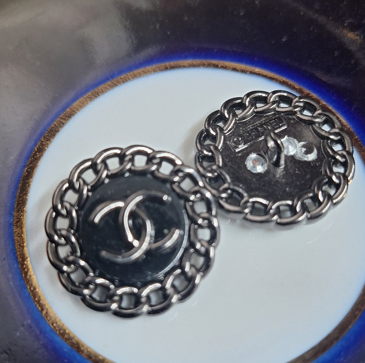 Buttons stamped black color. 23 mm