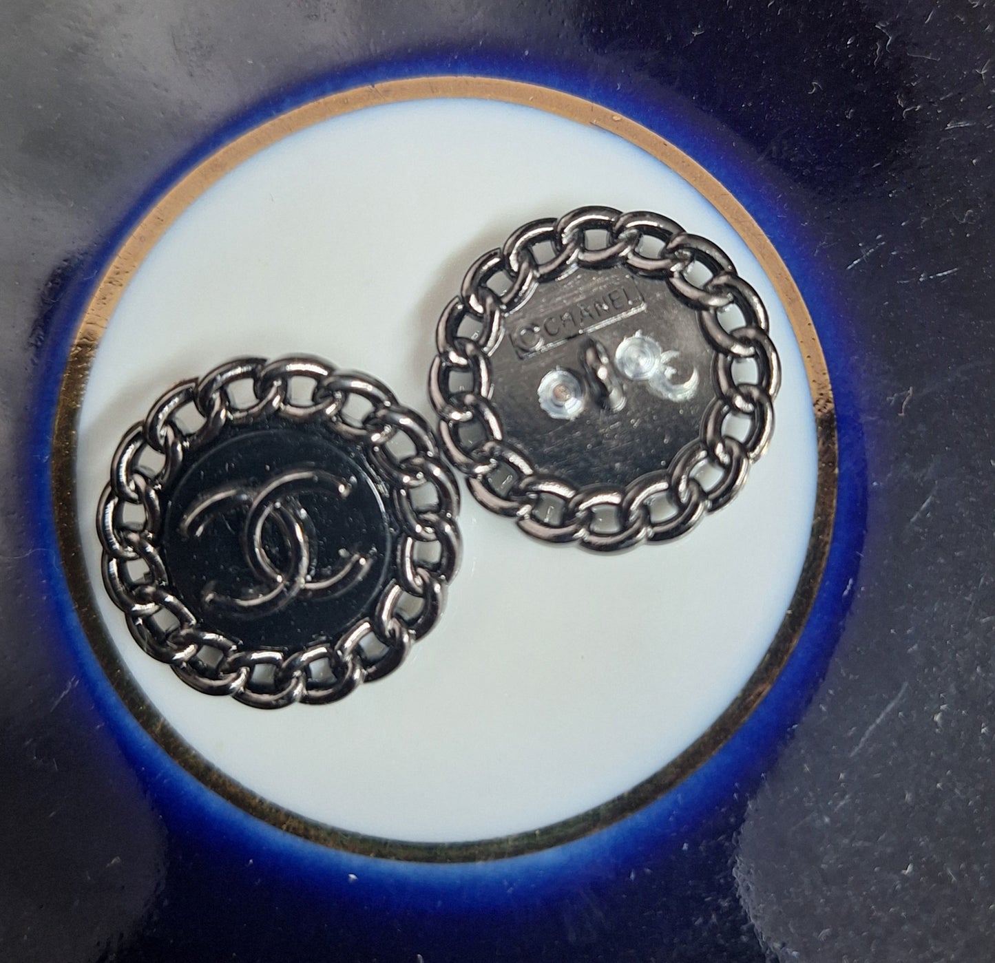 Buttons stamped black color. 23 mm