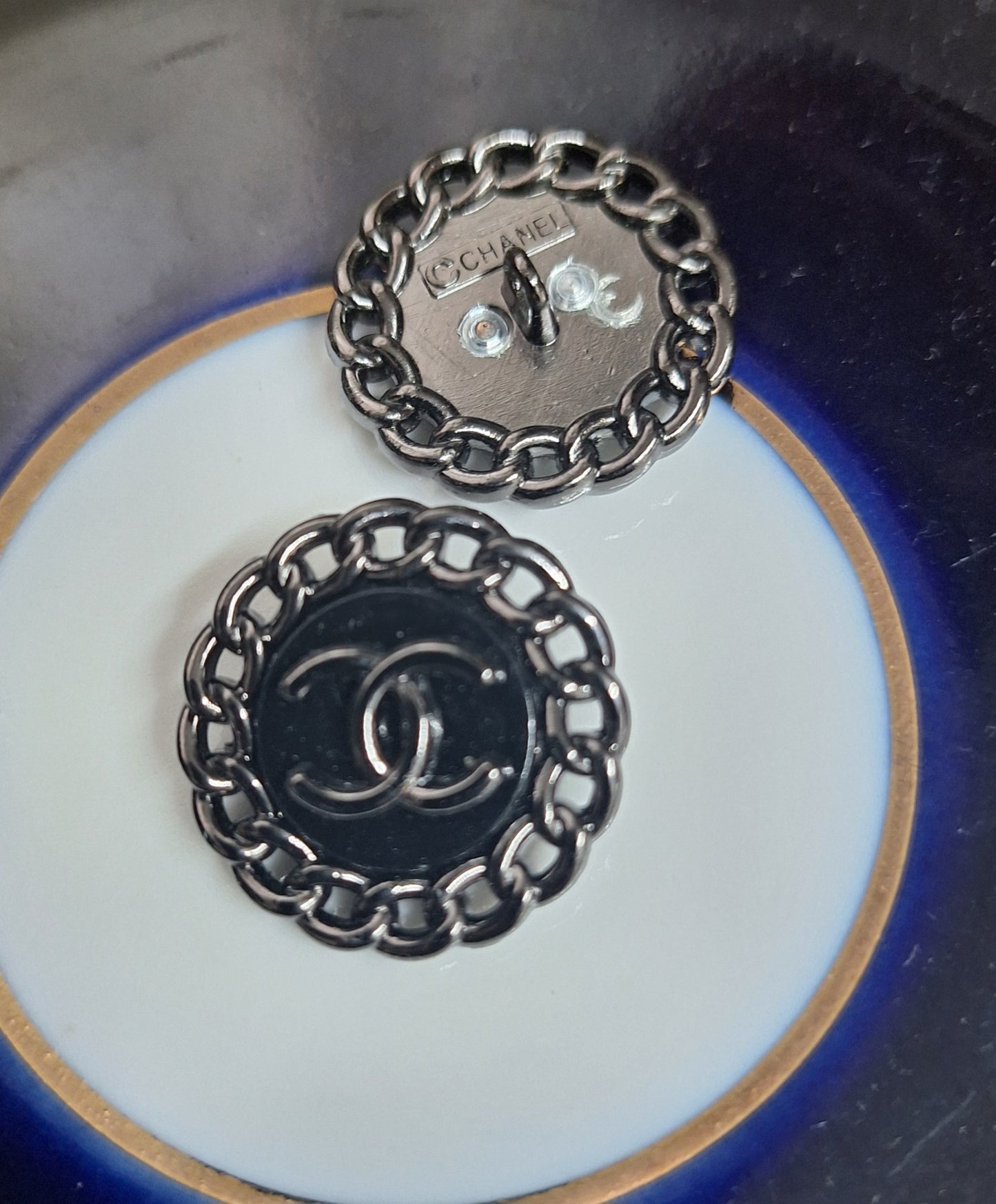 Buttons stamped black color. 23 mm