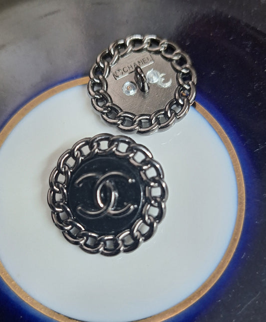 Buttons stamped black color. 23 mm