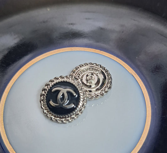 Buttons stamped. Silver & black enemal. 16 mm