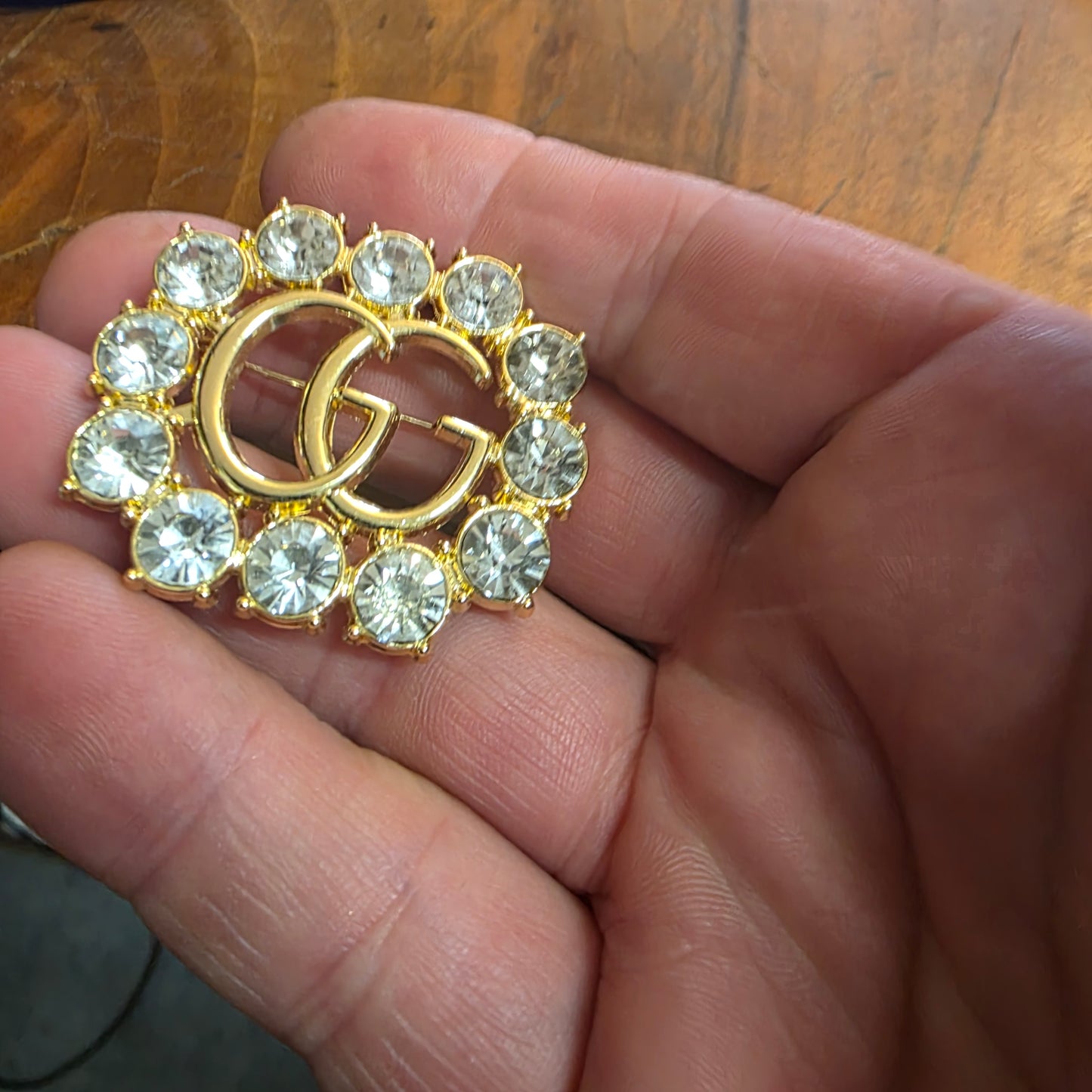Brooch 36/44 mm gold color, stemp, transparent zircon