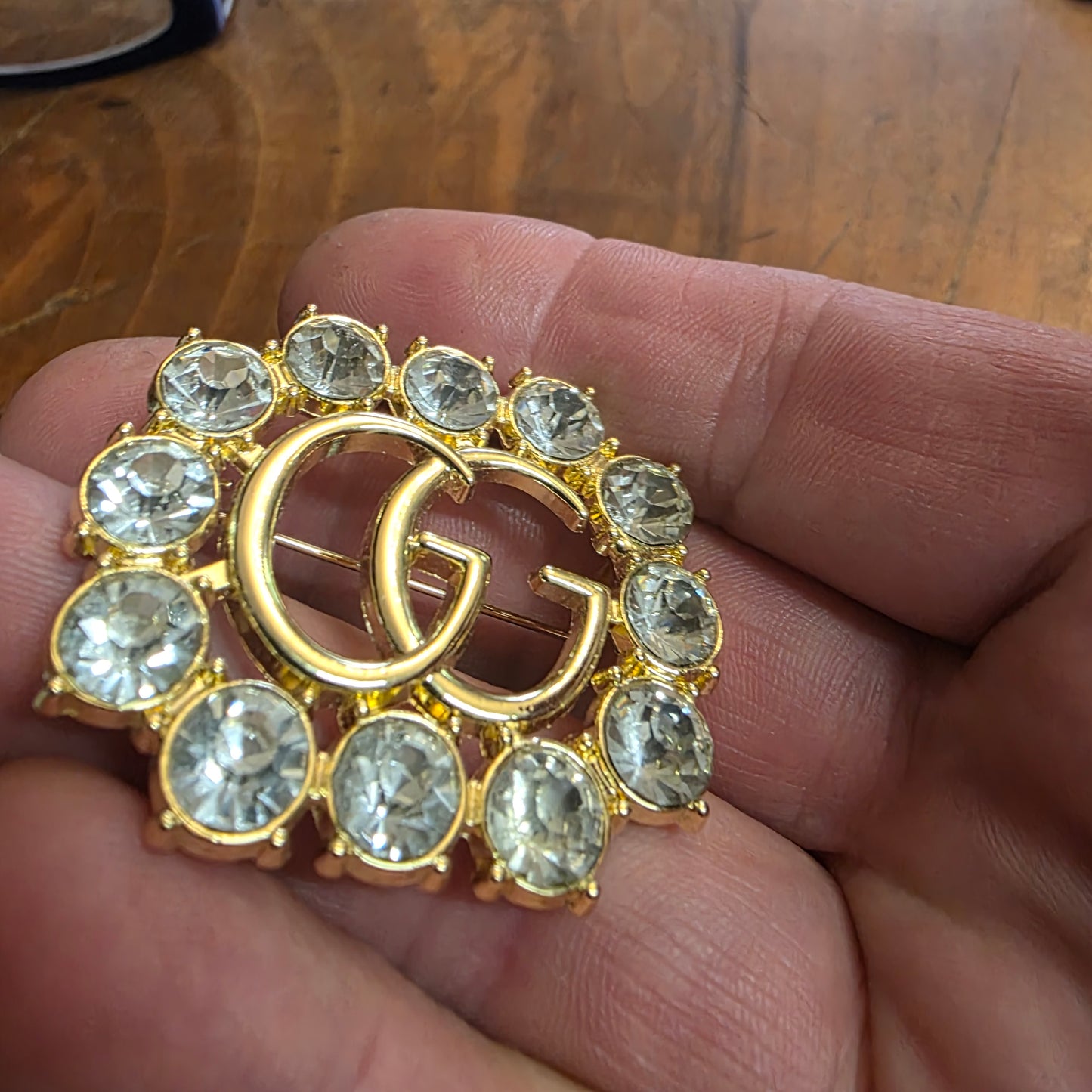 Brooch 36/44 mm gold color, stemp, transparent zircon