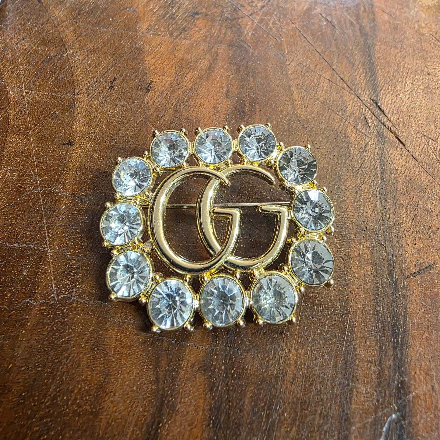 Brooch 36/44 mm gold color, stemp, transparent zircon