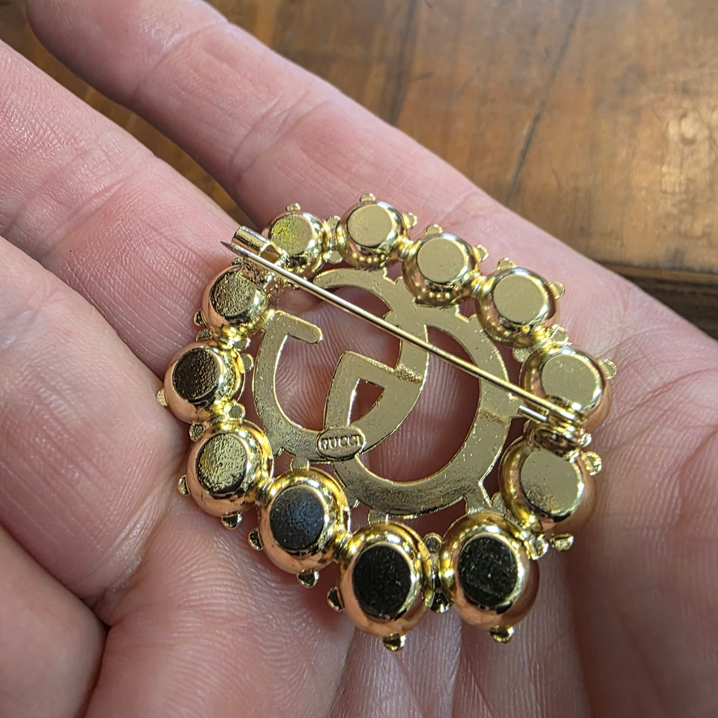 Brooch 36/44 mm gold color, stemp, transparent zircon